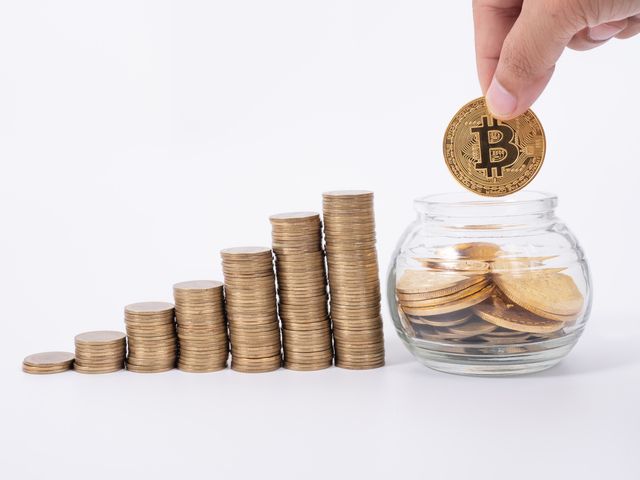 640-man-s-hand-put-money-coins-to-stack-of-cryptocurrency-money-financial-business-growth-concept.jpg