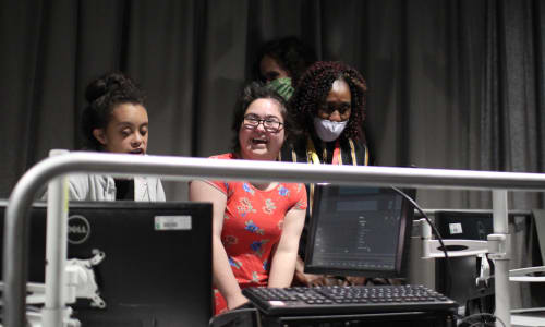 photo of a group of young people enjoying a technical theatre workshop