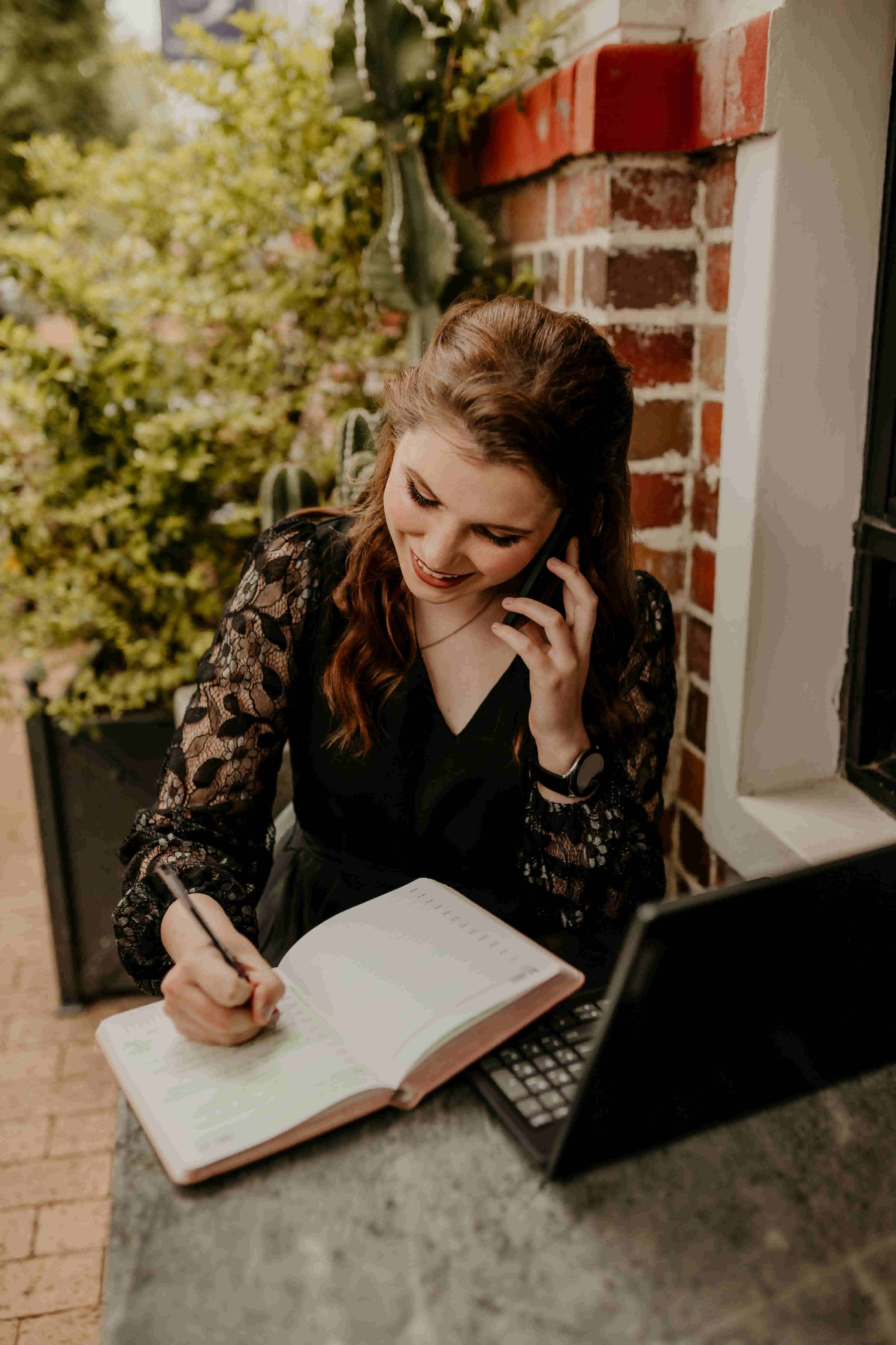 Planner writing in notebook