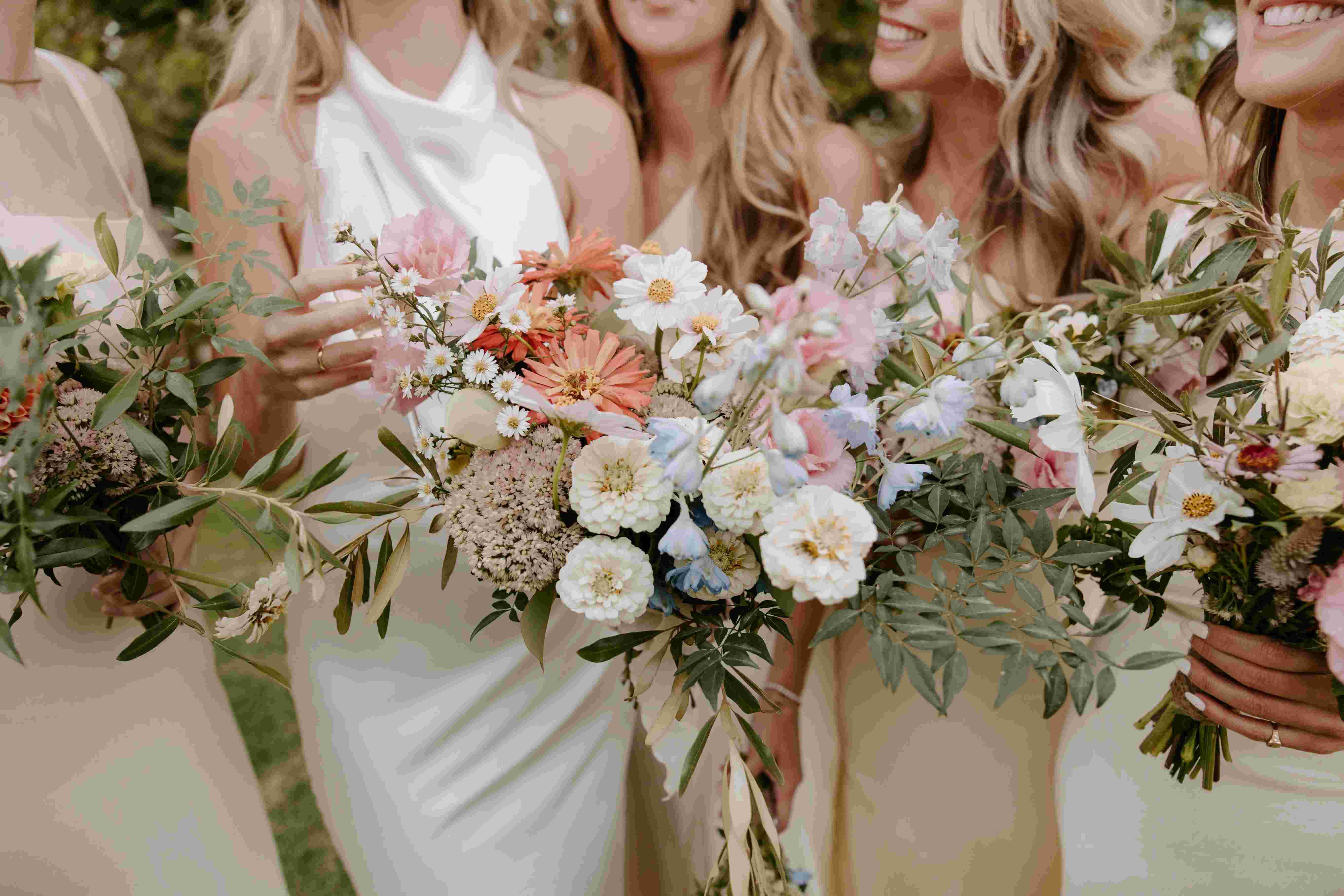Bridal party holding pastel florals
