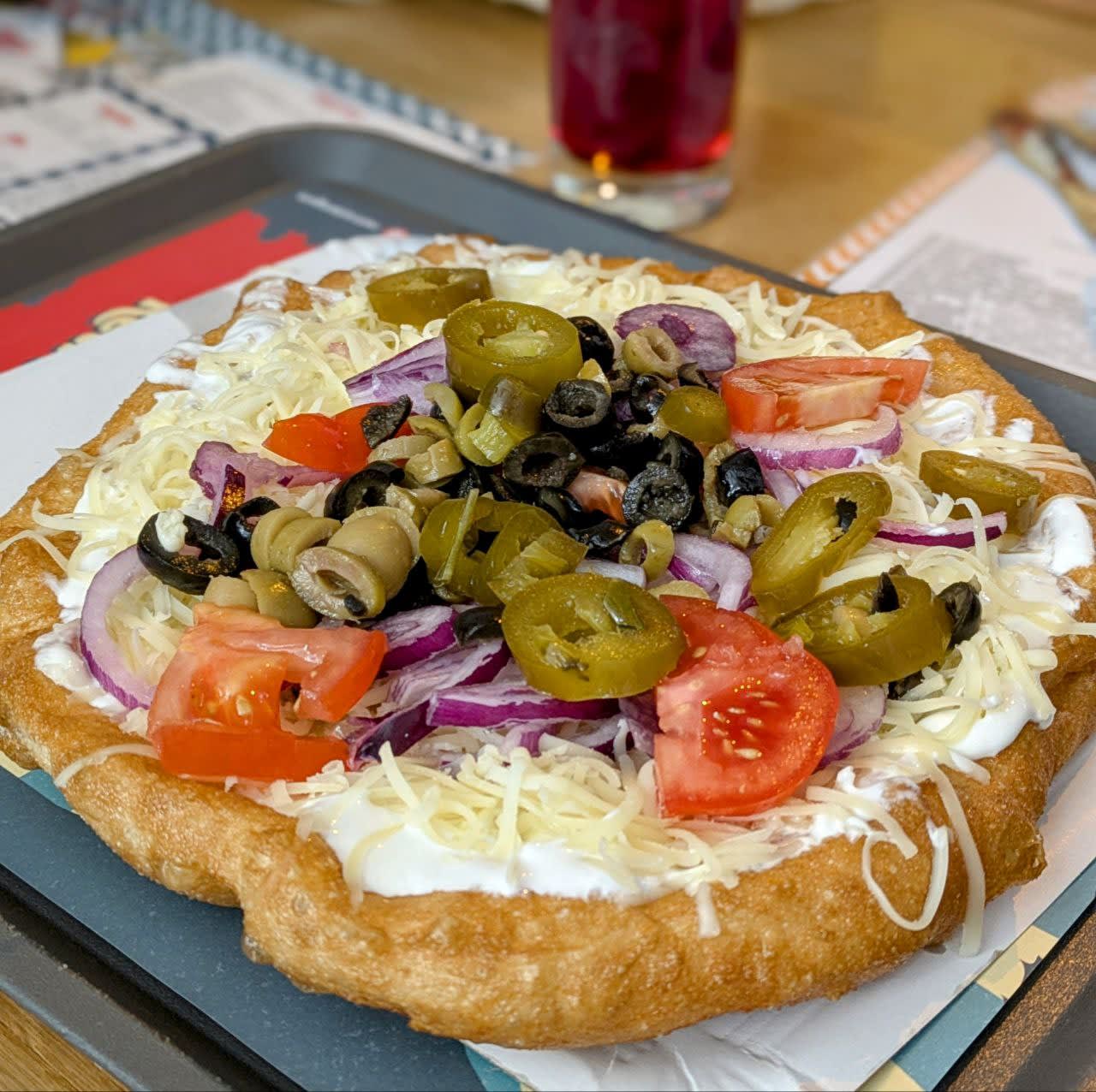 Langos (Fried bread, with sour cream and vegetables)
