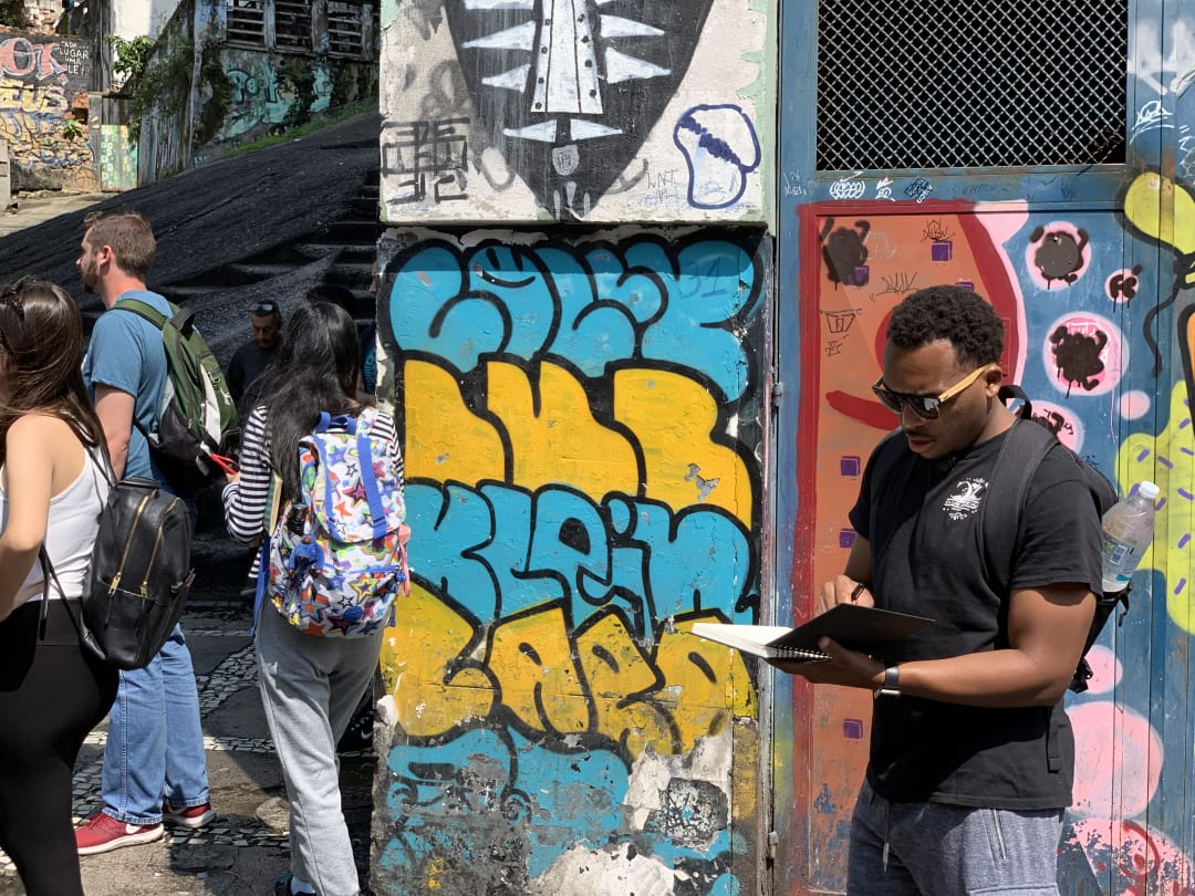 University students from the U.S. and Brazil work on design ideas during a Communities by Design field visit to Pedra do Sal, the birthplace of samba.