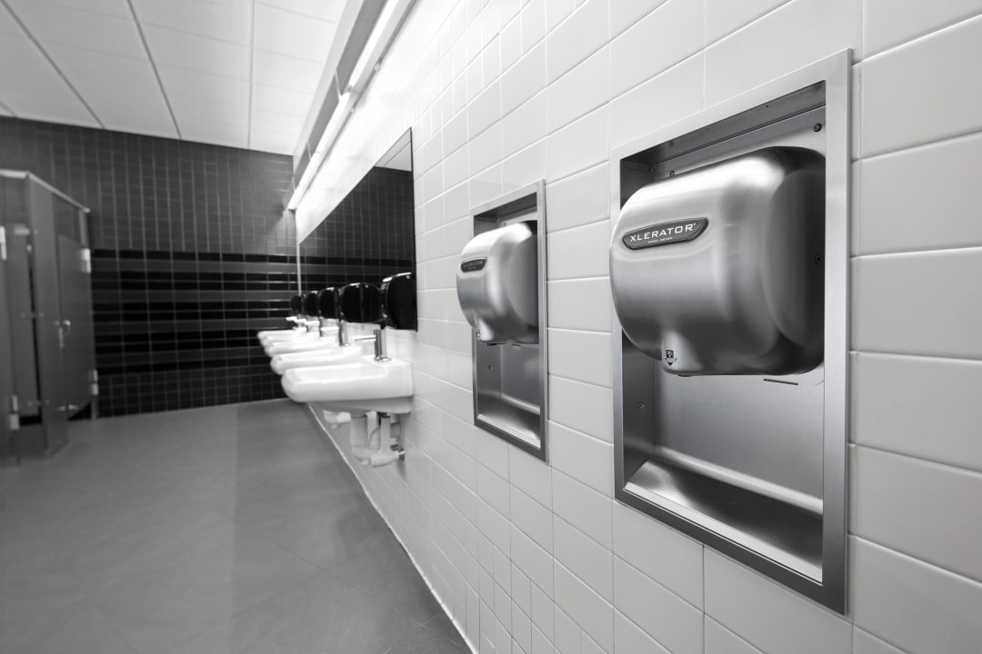 Two XLERATOR Hand Dryers in a school bathroom