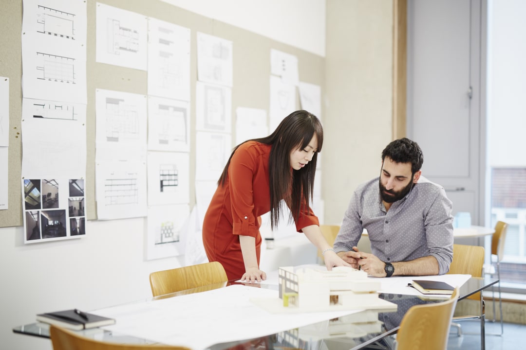 Two architects discussing a drawing