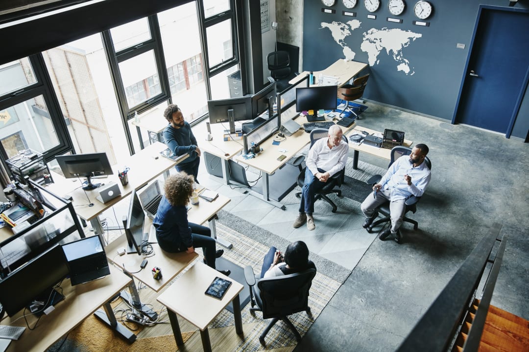 Aerial shot of a team brainstorming in an office space