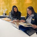 two women looking at book