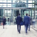 People walking in to and out of building entrance