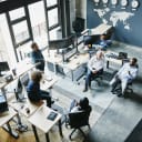Aerial shot of a team brainstorming in an office space