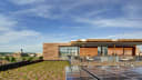 An image of the roof top. There is a covered terrace with seating, solar panels, and a lightly planted green roof space.