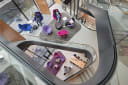 A Winding stair from above with a series of seating areas on the landings with purple and magenta chairs. 