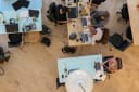 overhead of workers in an offices using laptops