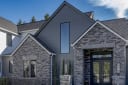 Transitional Tudor home by the Ginn Group featuring James Hardie siding