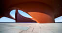 Red abstract buildings and open spaces illuminated by sunlight