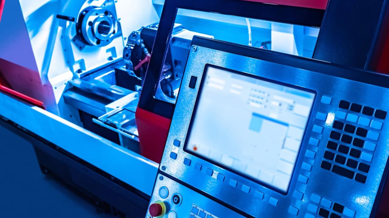 DAE Mechanical student learning CNC programming at a workshop in Pakistan