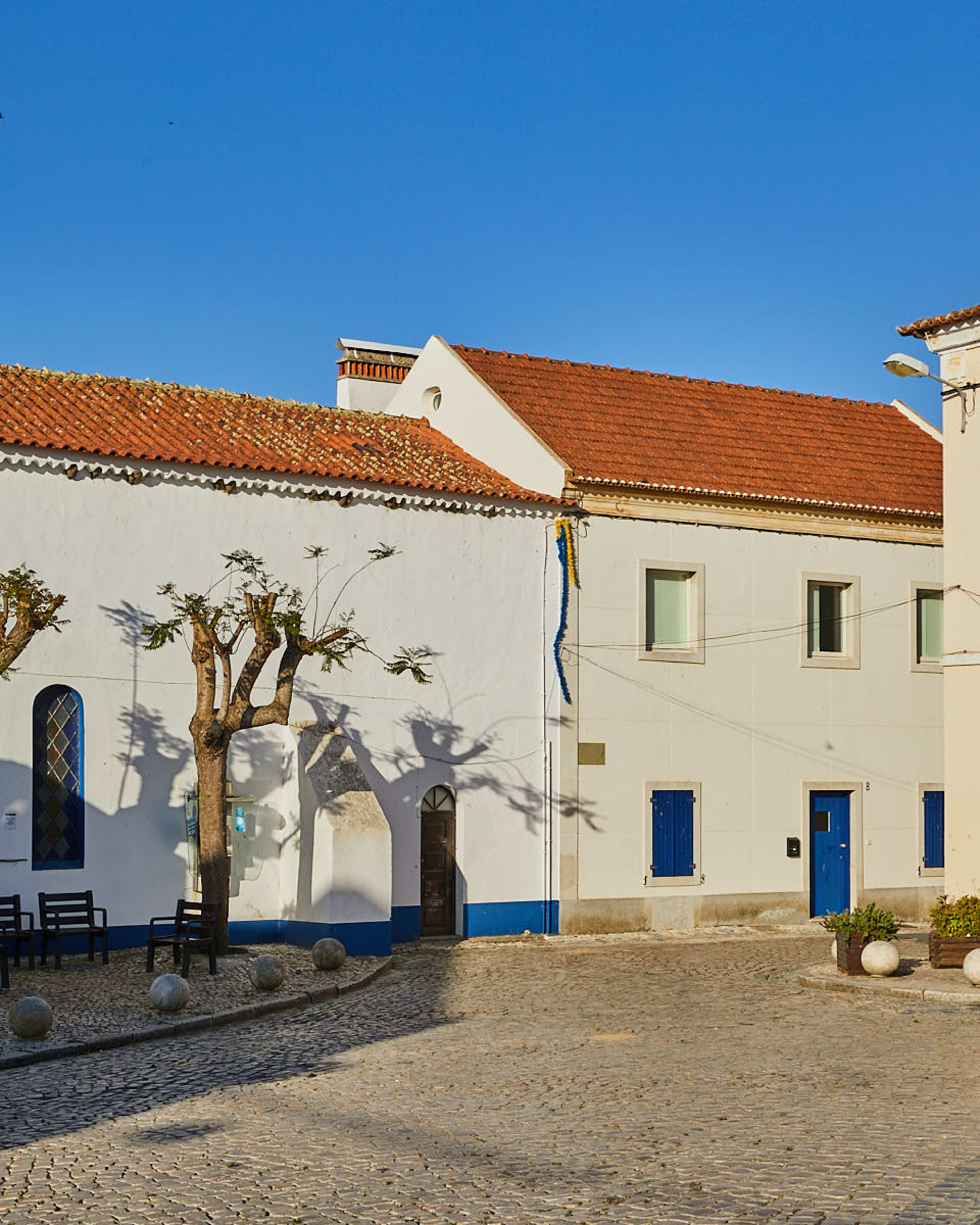 Whitewashed village house with blue trim, Melides
