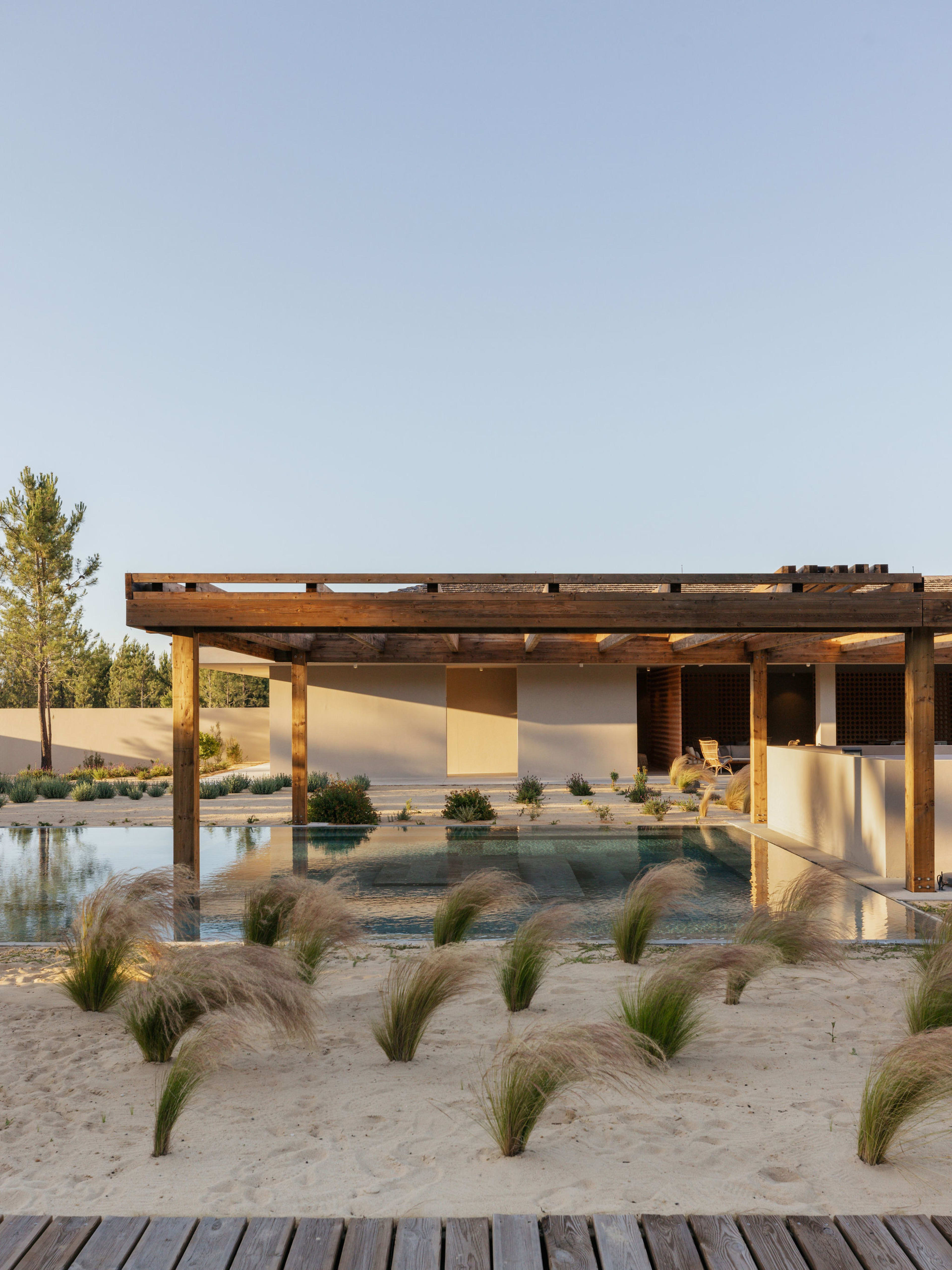 Timber pergola above a reflecting pool in the dune grasses