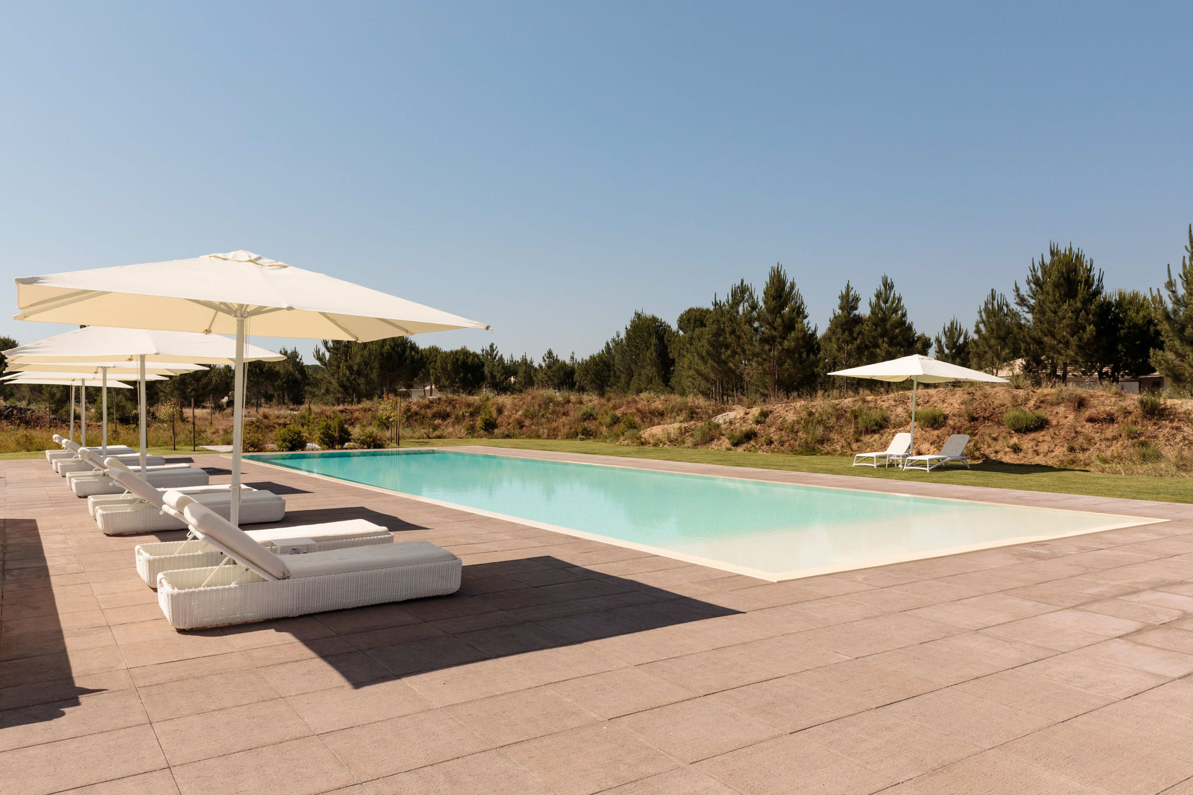 Daybeds and parasols on the pool terrace, Spatia Comporta