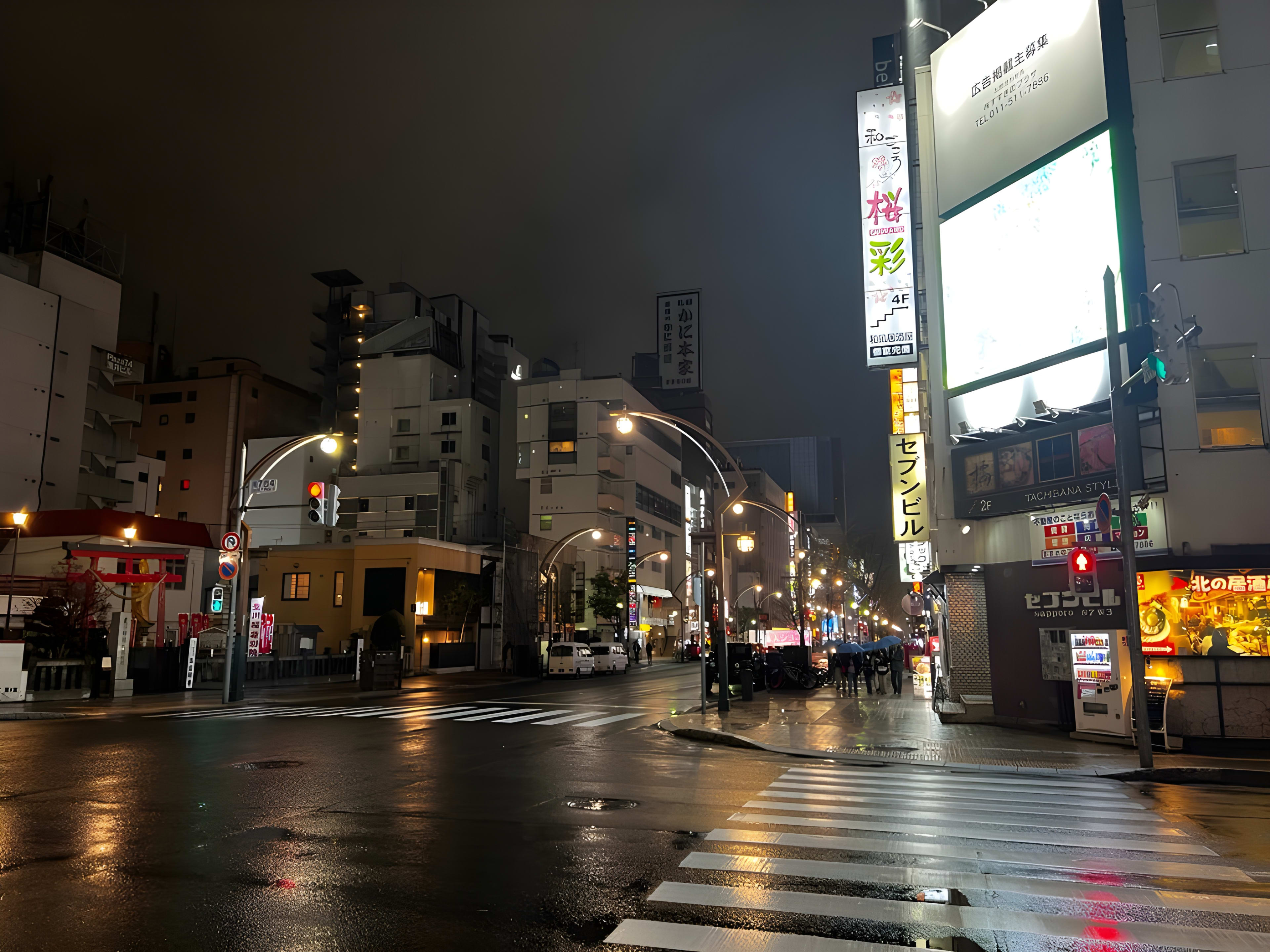 A serene city street at night in Japan, perfect for a japan itinerary; wet pavement glistens under warm streetlights and glowing building signs, with only a few pedestrians and cars present, evoking tranquility on an evening stroll.