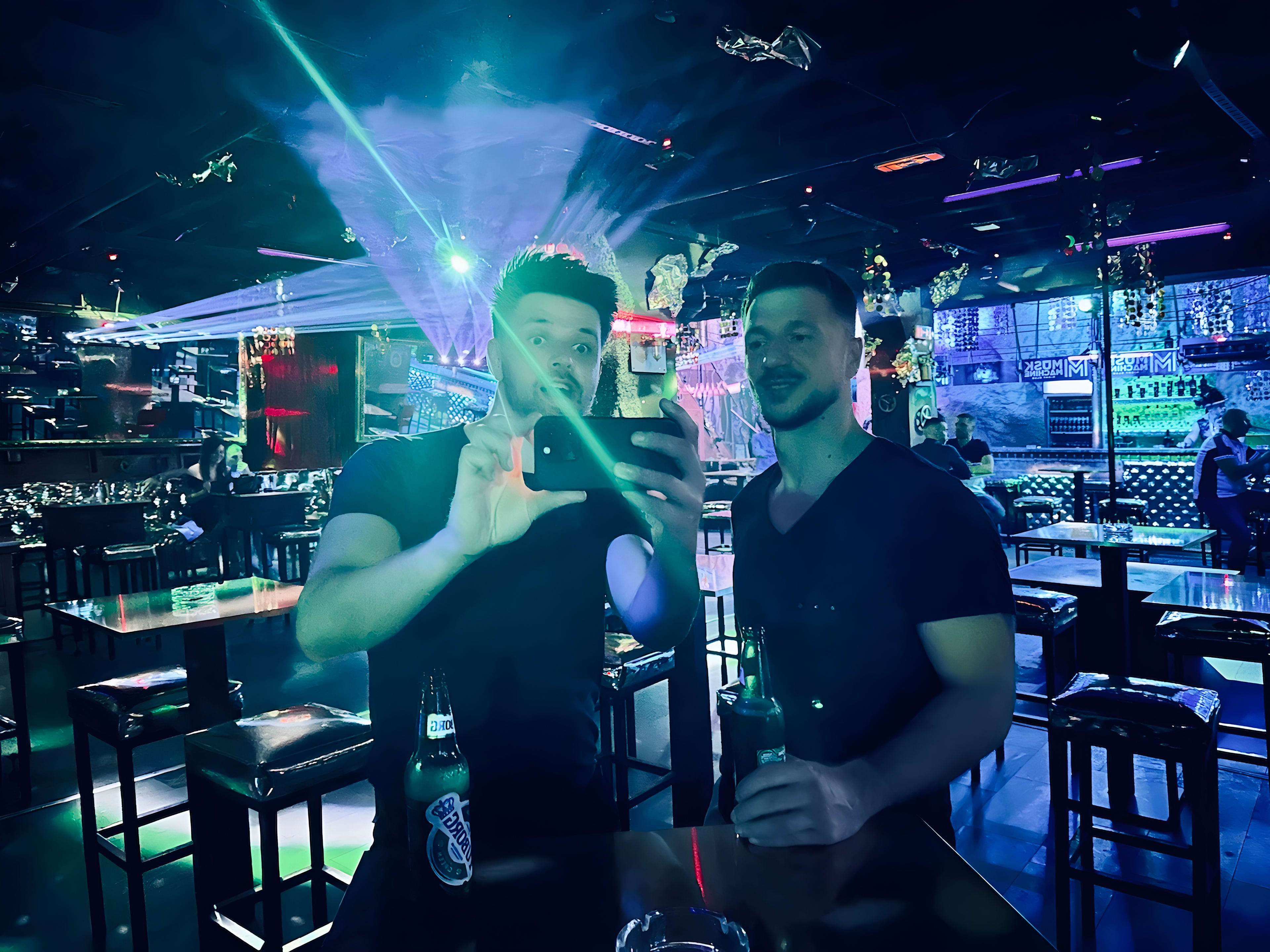 The interior of Musk Machine in Belgrade, featuring industrial and gothic design elements. A person is sitting on a throne-like chair, embodying the club's dramatic and edgy aesthetic.