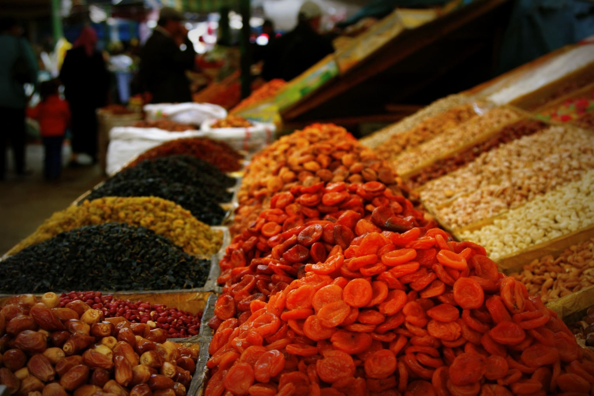 Colorful display of dried fruits and nuts at Osh Bazaar in Bishkek, Kyrgyzstan, a vibrant place to explore local flavors and shop.