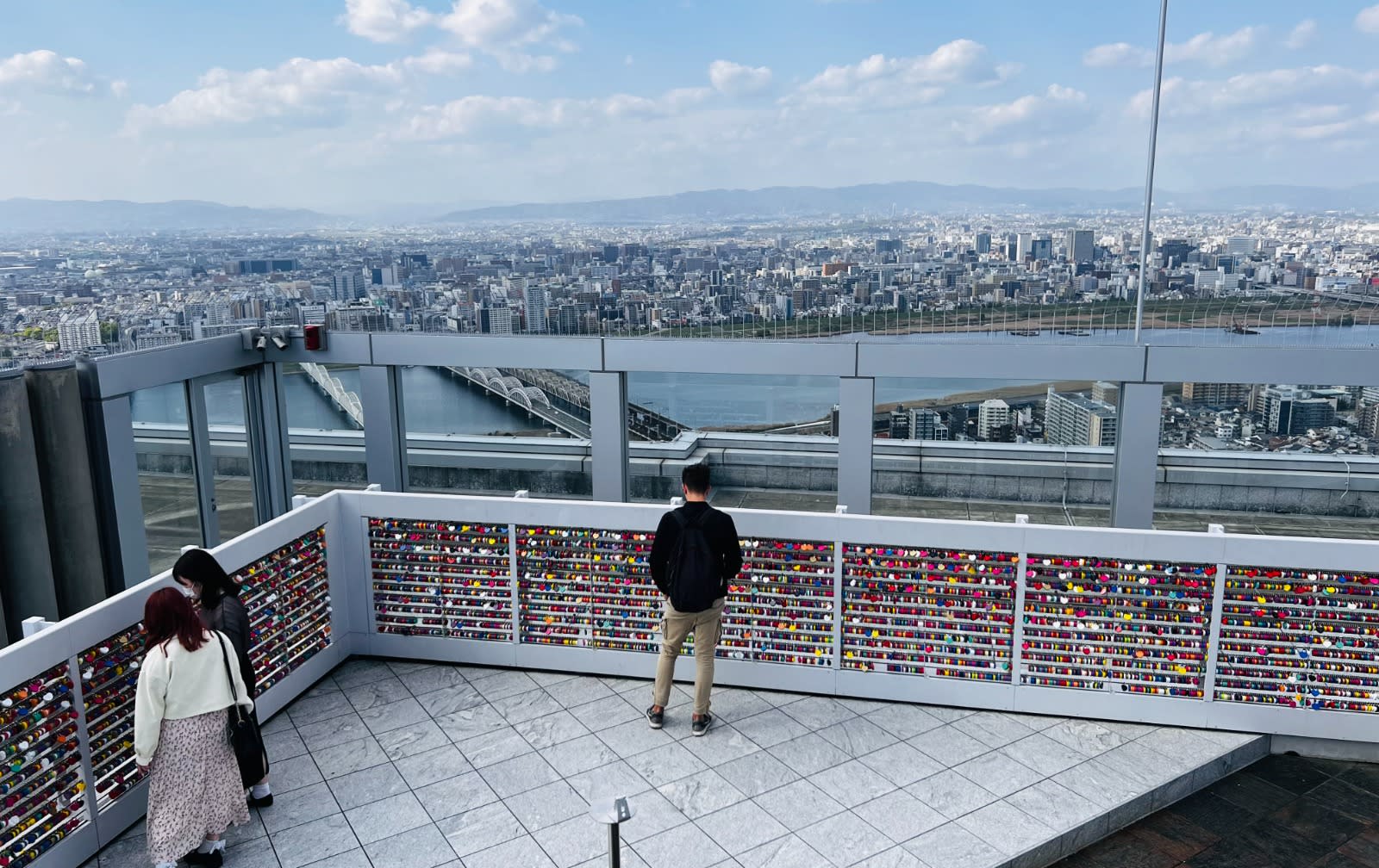 A panoramic view from the observation deck of the Umeda Sky Building in Osaka, Japan, showing the city skyline and the Yodogawa River. This spot provides breathtaking vistas and is a highlight of any Honshu Japan itinerary.