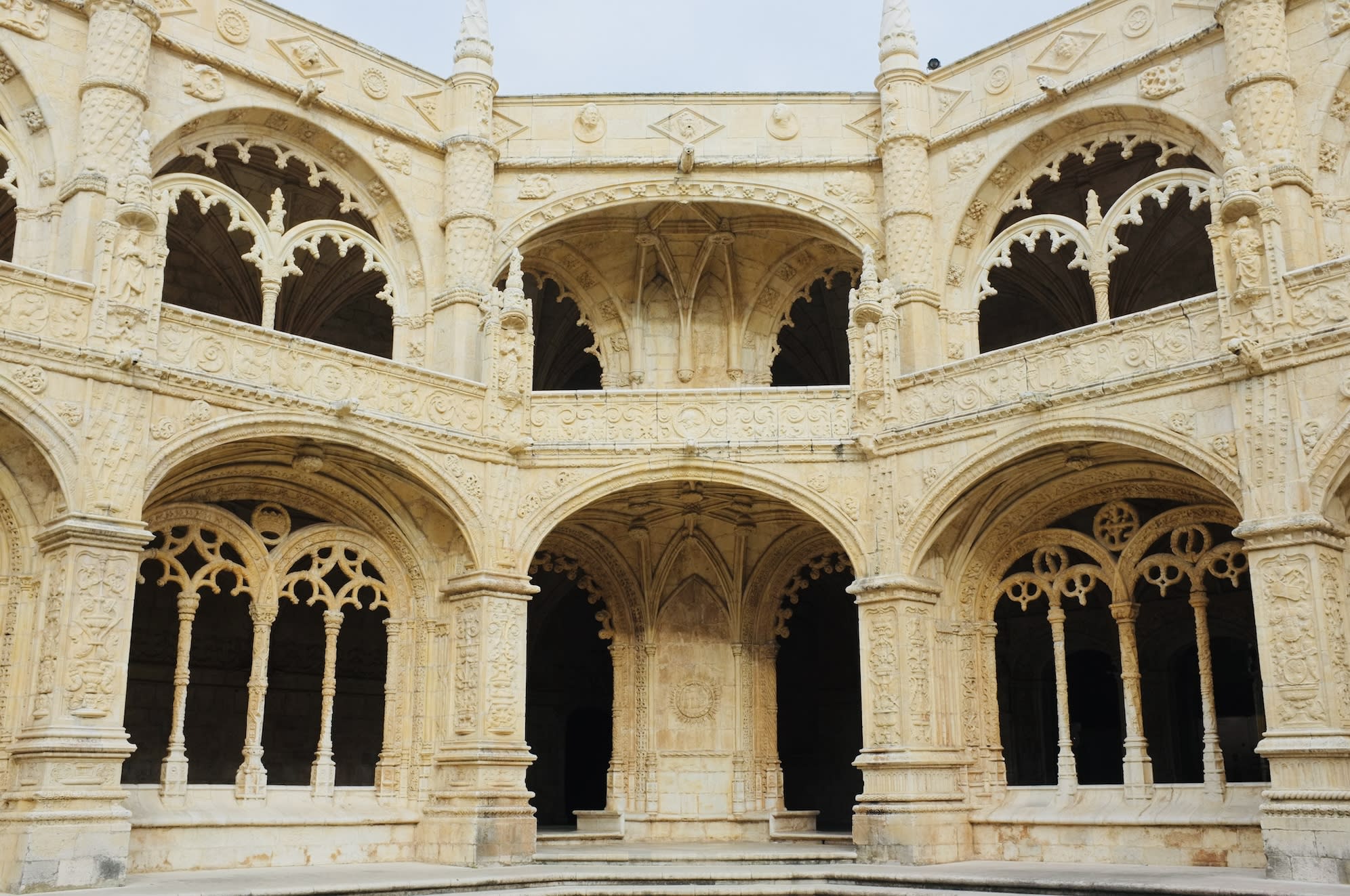 The ornate cloisters of the Jerónimos Monastery, showcasing the historical and architectural grandeur of gay Lisbon.