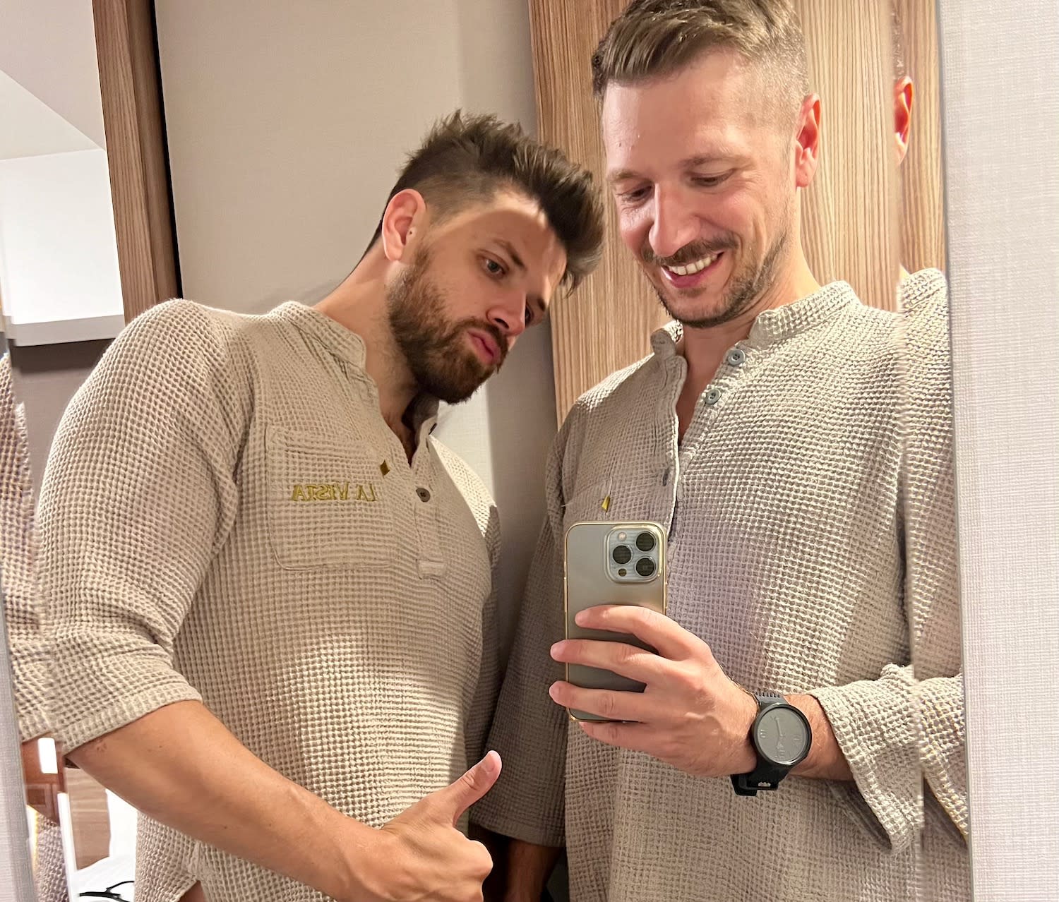 Two men taking a mirror selfie wearing traditional Japanese yukatas.