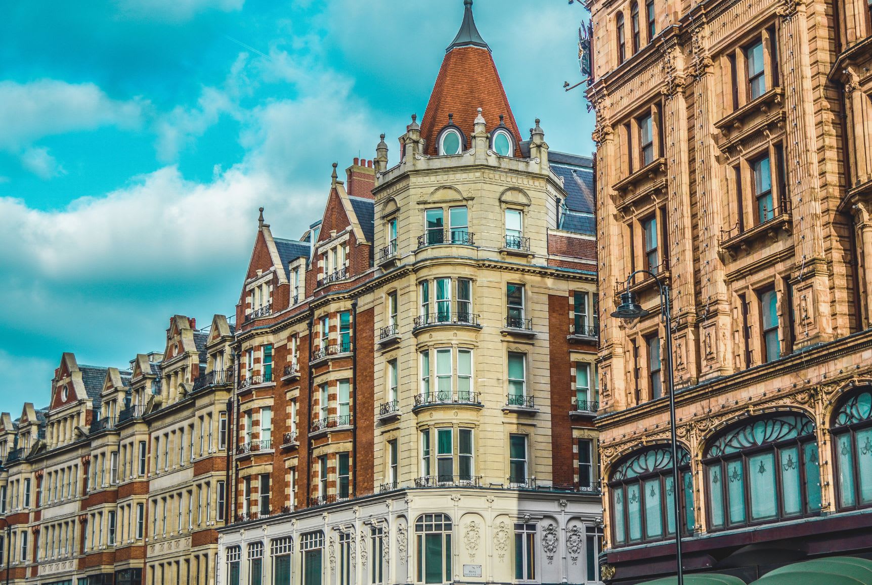 The elegant and ornate architecture of London's Kensington buildings, embodying the grandeur and history appreciated in Gay London circles.