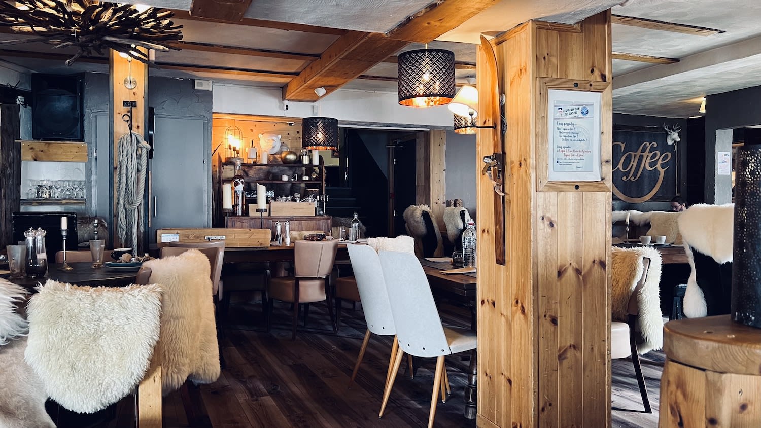 Inside a stylish ski lodge with plush seating and a rustic-chic decor, inviting guests to unwind after the day's events at the European Snow Pride in Tignes.
