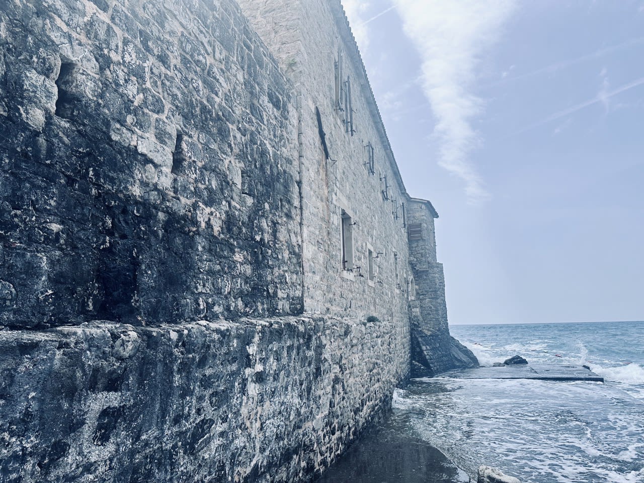 The rugged stone walls of Budva’s Old Town Fort meeting the Adriatic Sea, offering a glimpse into Montenegro’s coastal history. A must-visit site when listing things to do in Kotor and its surroundings.