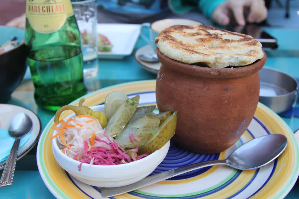 A traditional Georgian meal served in Tbilisi, one of the best cities for digital nomads, featuring rich culture, low living costs, and a thriving expat community.