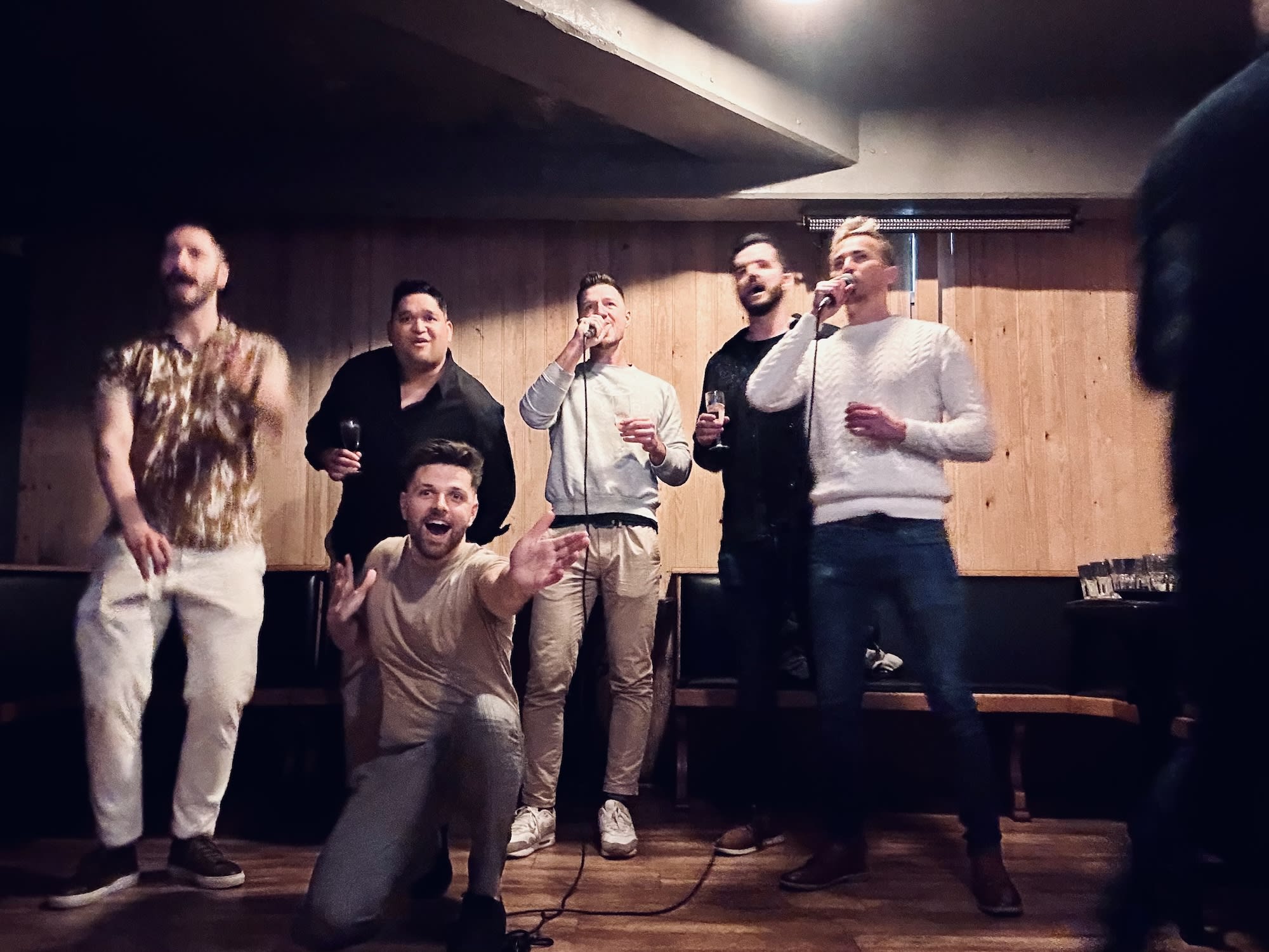 The interior of The Lanes, a lively venue in Bristol known for its bowling lanes and late-night events. Patrons are seated at tables, enjoying drinks in a casual, industrial-chic setting that often hosts LGBTQ+ events.