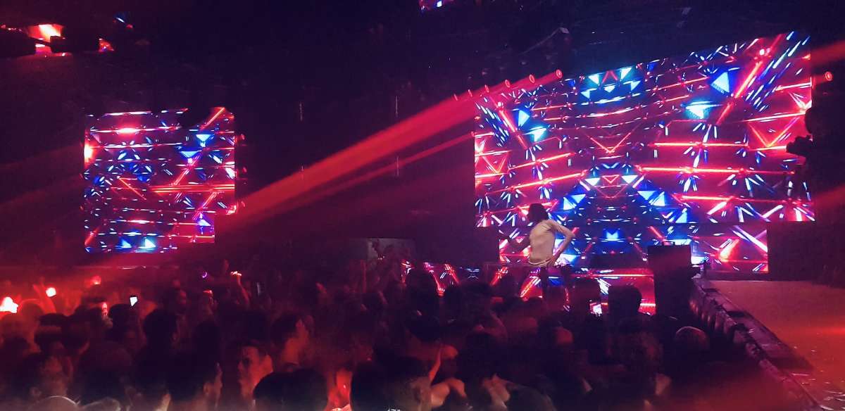 Dazzling red and blue stage lights at Sexy in the Club Boothaus in Cologne, with a crowd enjoying the dynamic entertainment scene that gay Cologne is known for.