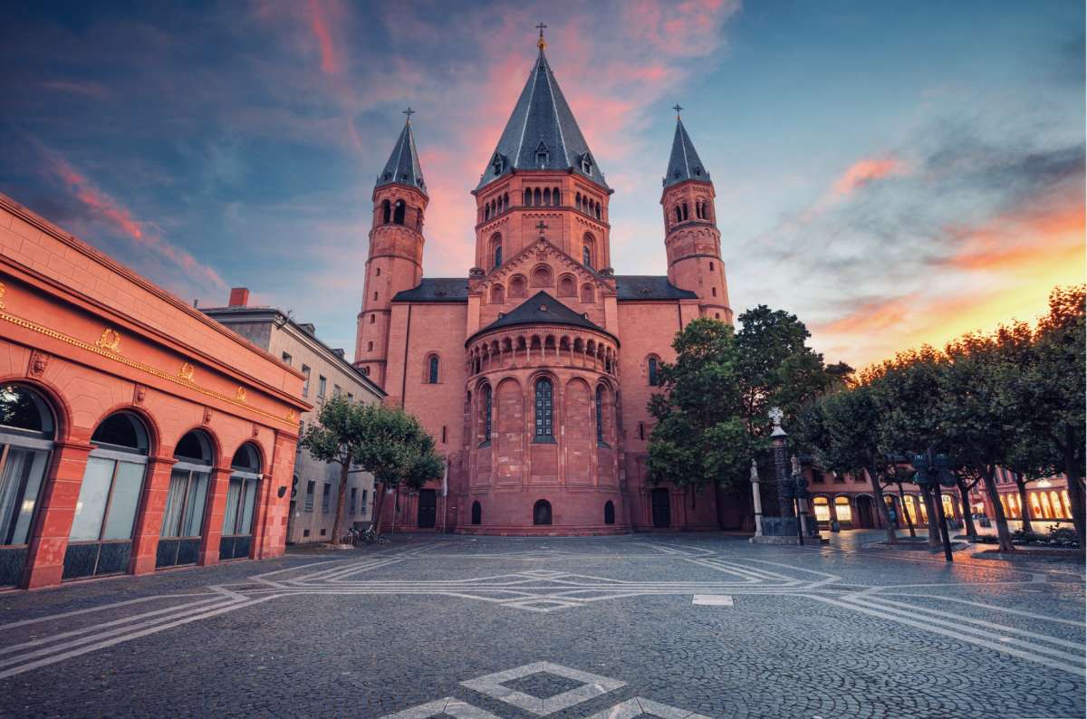 Majestic red sandstone church of Mainz Cathedral bathed in sunset hues, reflecting the city's rich cultural heritage.