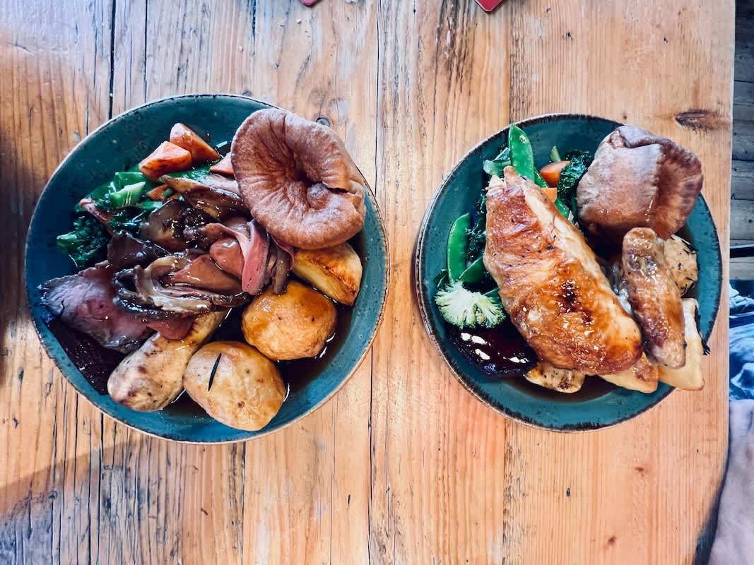 Traditional Sunday roast dinners served in a rustic Brighton pub, illustrating the culinary delights available in gay Brighton's dining scene.