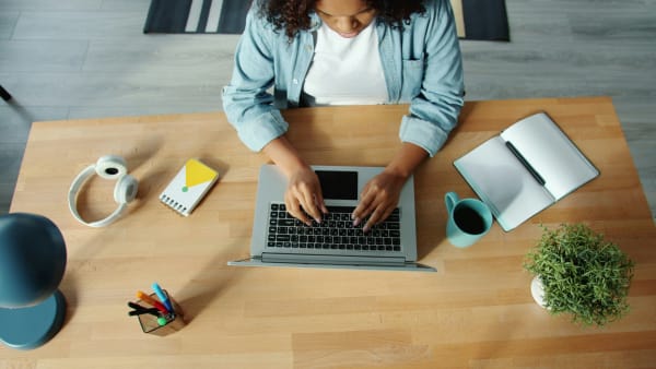 Lady sat a table working on a laptop