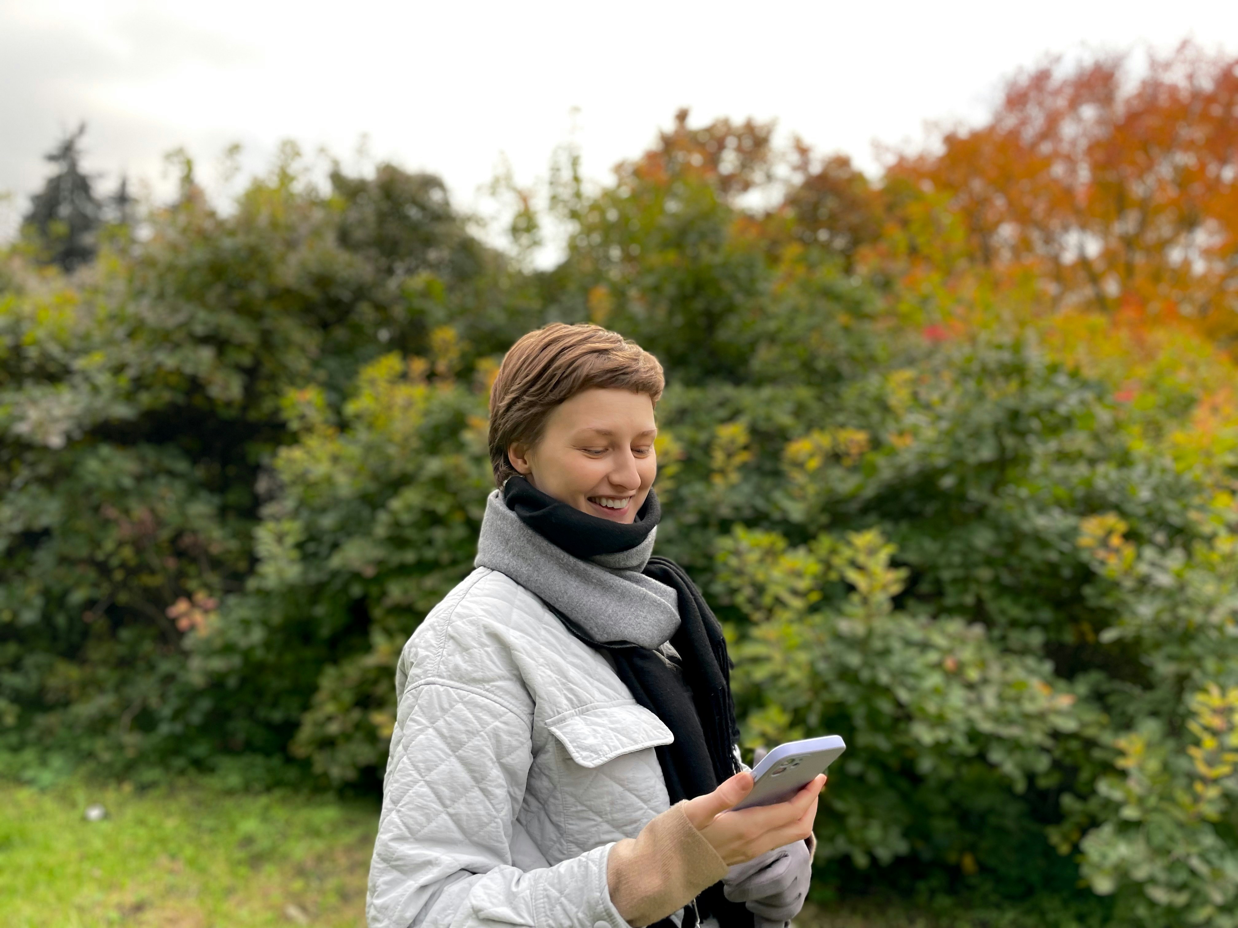 smiling lady looking at mobile phone