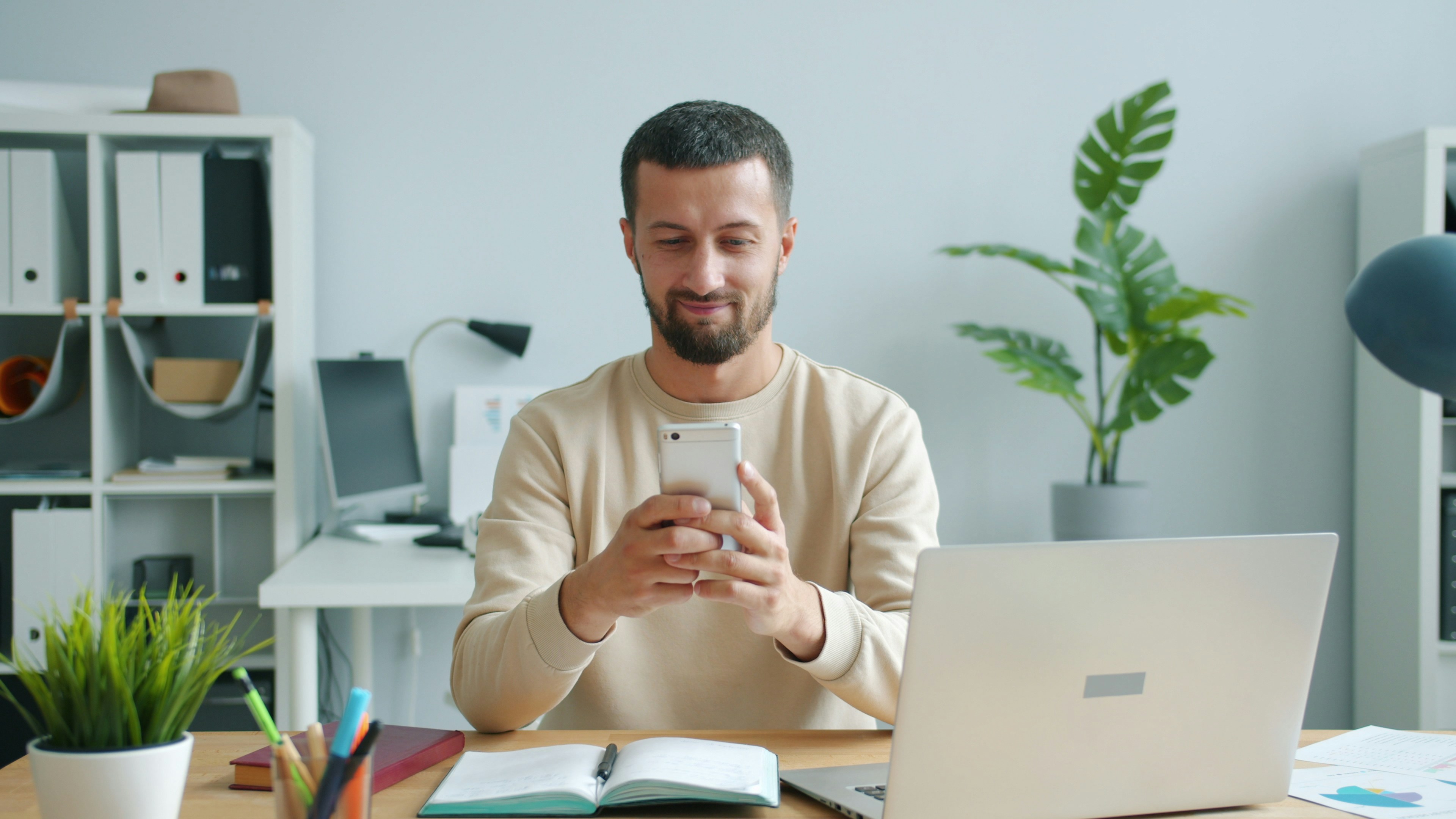 man smiling looking at mobile phone