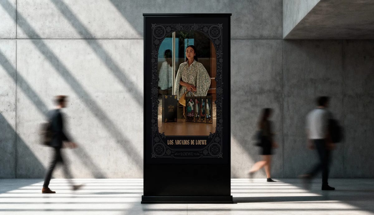 Mupi del proyecto Los Arcanos de Loewe en un espacio público con personas pasando, de Ánder Sánchez, alumno de Diseño Gráfico y Motion Graphics en TRAZOS