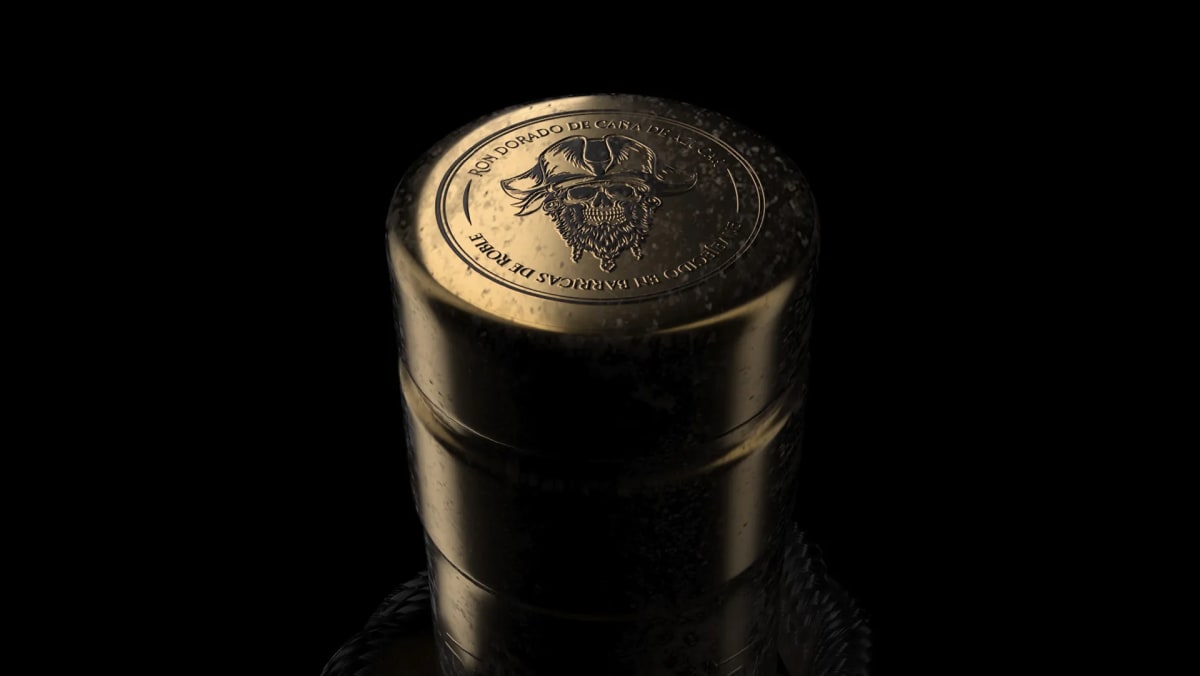 Tapón dorado del ron pirata Barbanegra con medallón de calavera sobre fondo negro, de Ánder Sánchez, alumno de Diseño Gráfico y Motion Graphics en TRAZOS