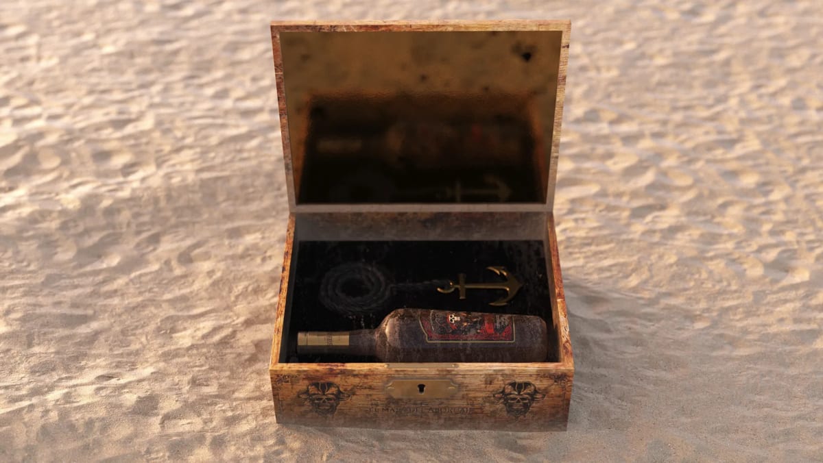 Cofre de madera abierto con la botella del ron pirata Barbanegra sobre la arena, de Ánder Sánchez, alumno de Diseño Gráfico y Motion Graphics en TRAZOS