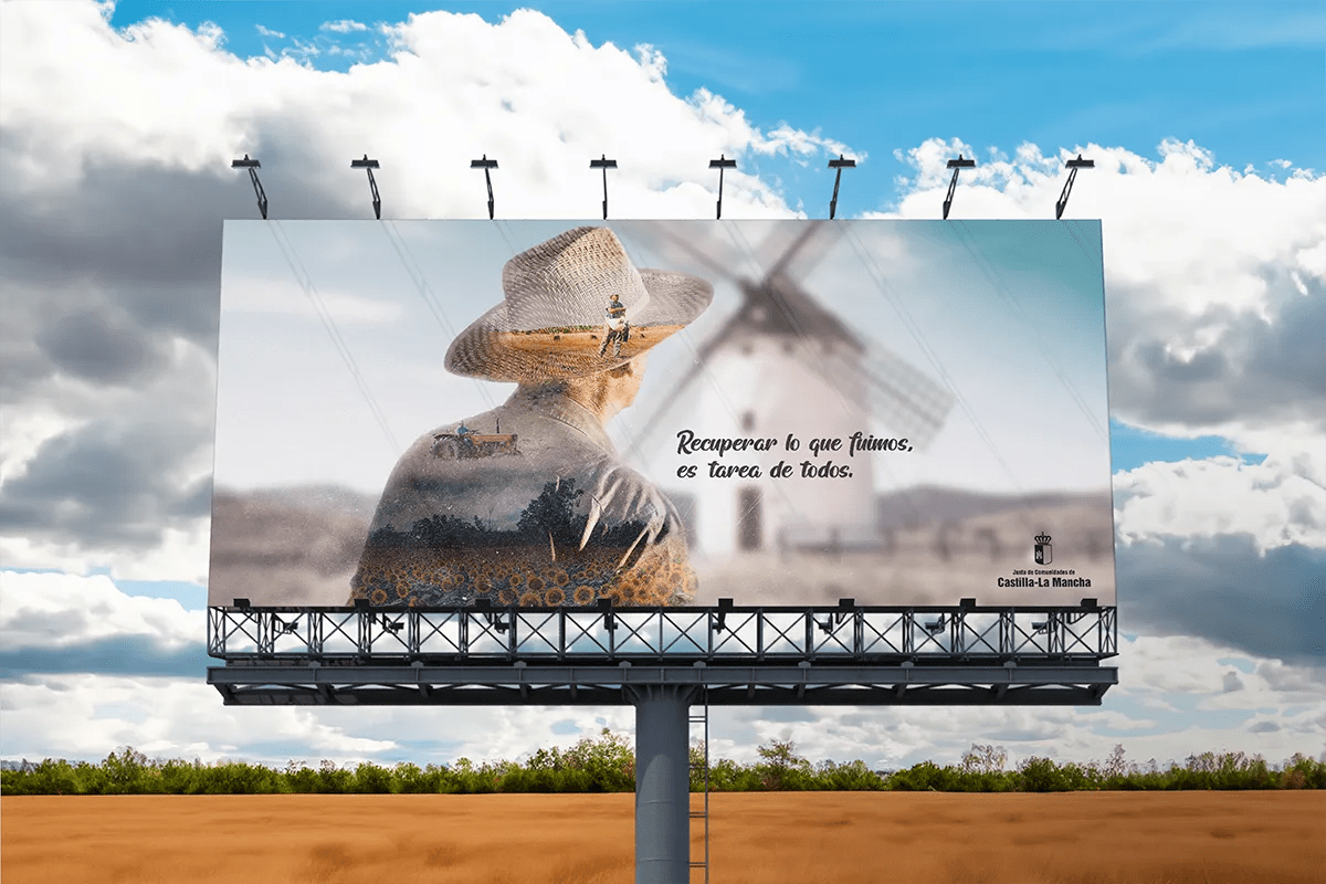 Valla publicitaria de la campaña Recuperar lo que fuimos de Castilla-La Mancha con retrato a doble exposicion y molino al fondo, de Diseño Gráfico y Motion Graphics en TRAZOS