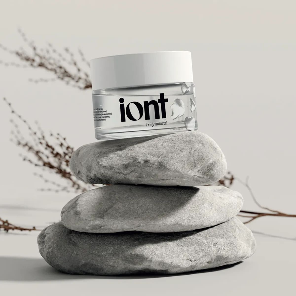Tarro de cosmética natural de la marca iont sobre piedras apiladas, de Rita García, alumna de Diseño Gráfico y Motion Graphics en TRAZOS