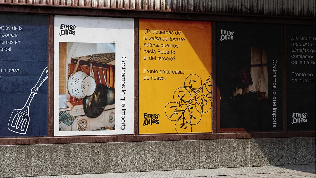 Fachada exterior con escaparates rotulados con la identidad de la marca Entre Ollas, de Marina Gabilondo Calleja, alumna de Diseño Gráfico y Motion Graphics en TRAZOS