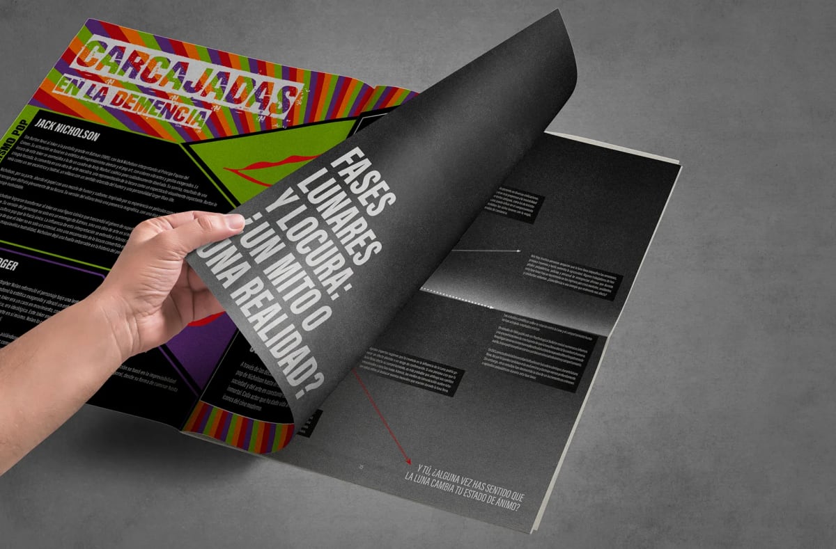 Mano pasando la página carcajadas en la demencia de la revista La Locura, de Alexander y Neus, alumnos de Diseño Gráfico y Motion Graphics en TRAZOS