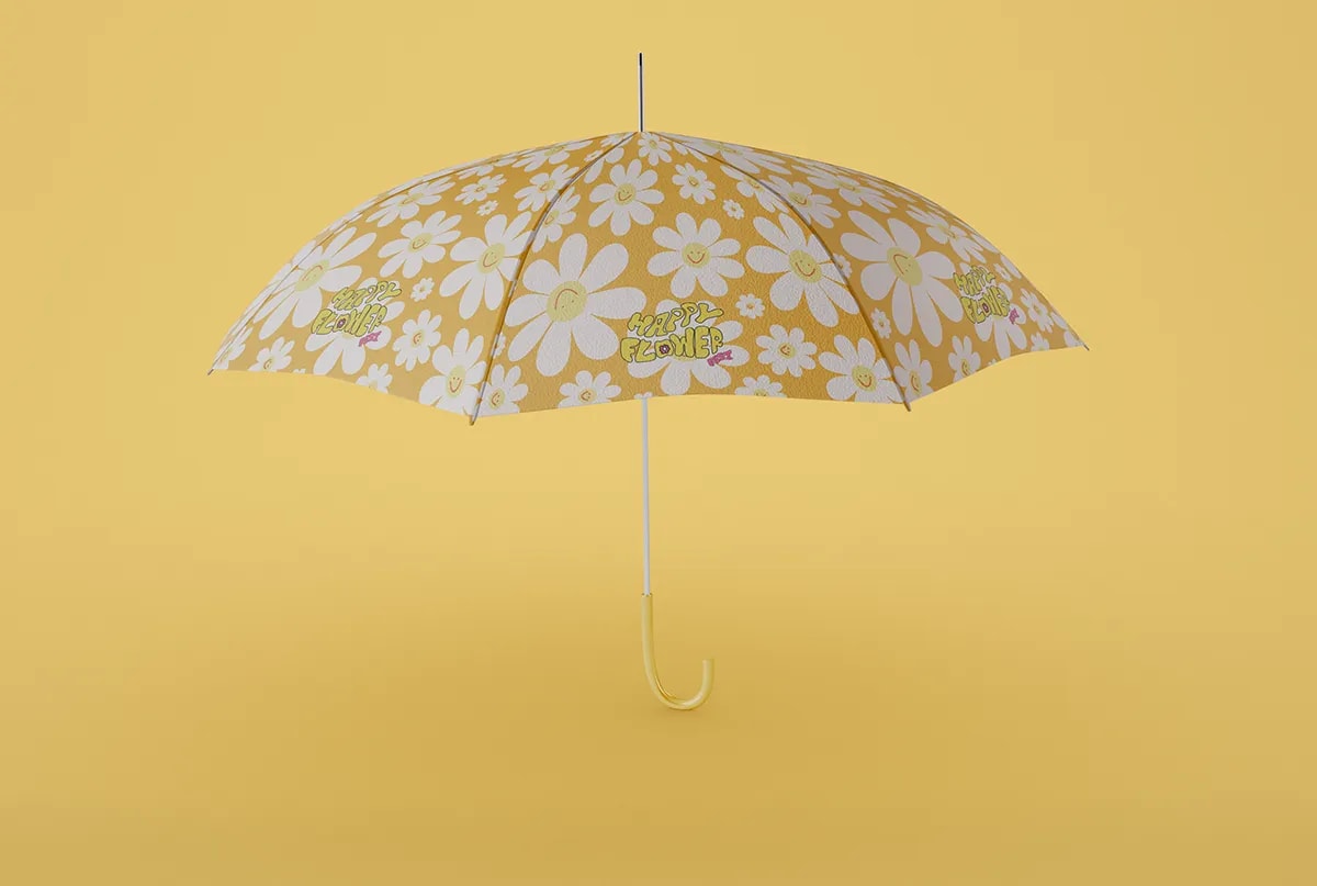 Paraguas de Happy Flower Fest con estampado de margaritas sobre fondo amarillo, de Sofía Villalta, alumna de Diseño Gráfico y Motion Graphics en TRAZOS
