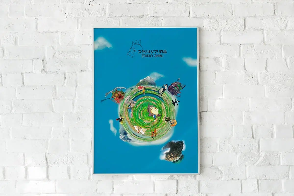 Cartel homenaje a Studio Ghibli enmarcado en una pared de ladrillo blanco, de Guillermo Gómez Barroso, alumno de Diseño Gráfico y Motion Graphics en TRAZOS