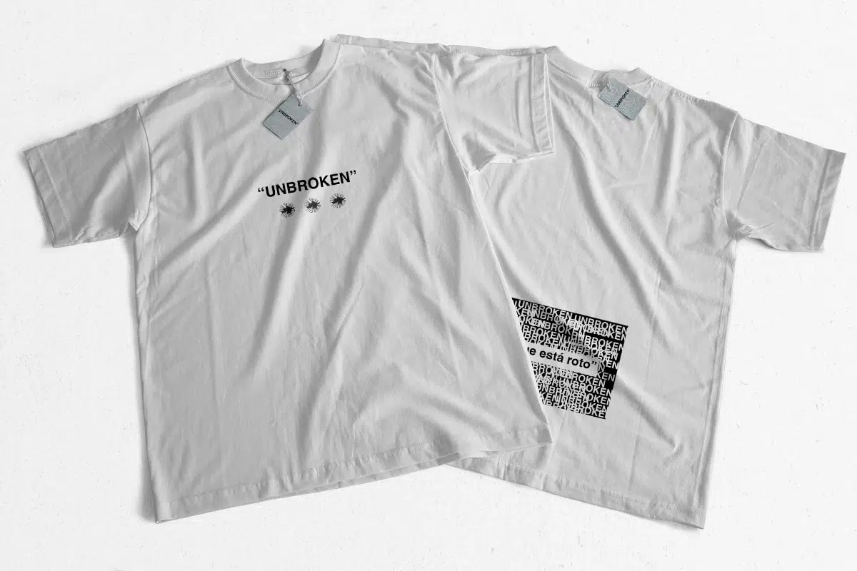 Dos camisetas blancas del Unbroken Festival con tipografía y etiqueta de marca, de María Delgado, alumna de Diseño Gráfico y Motion Graphics en TRAZOS