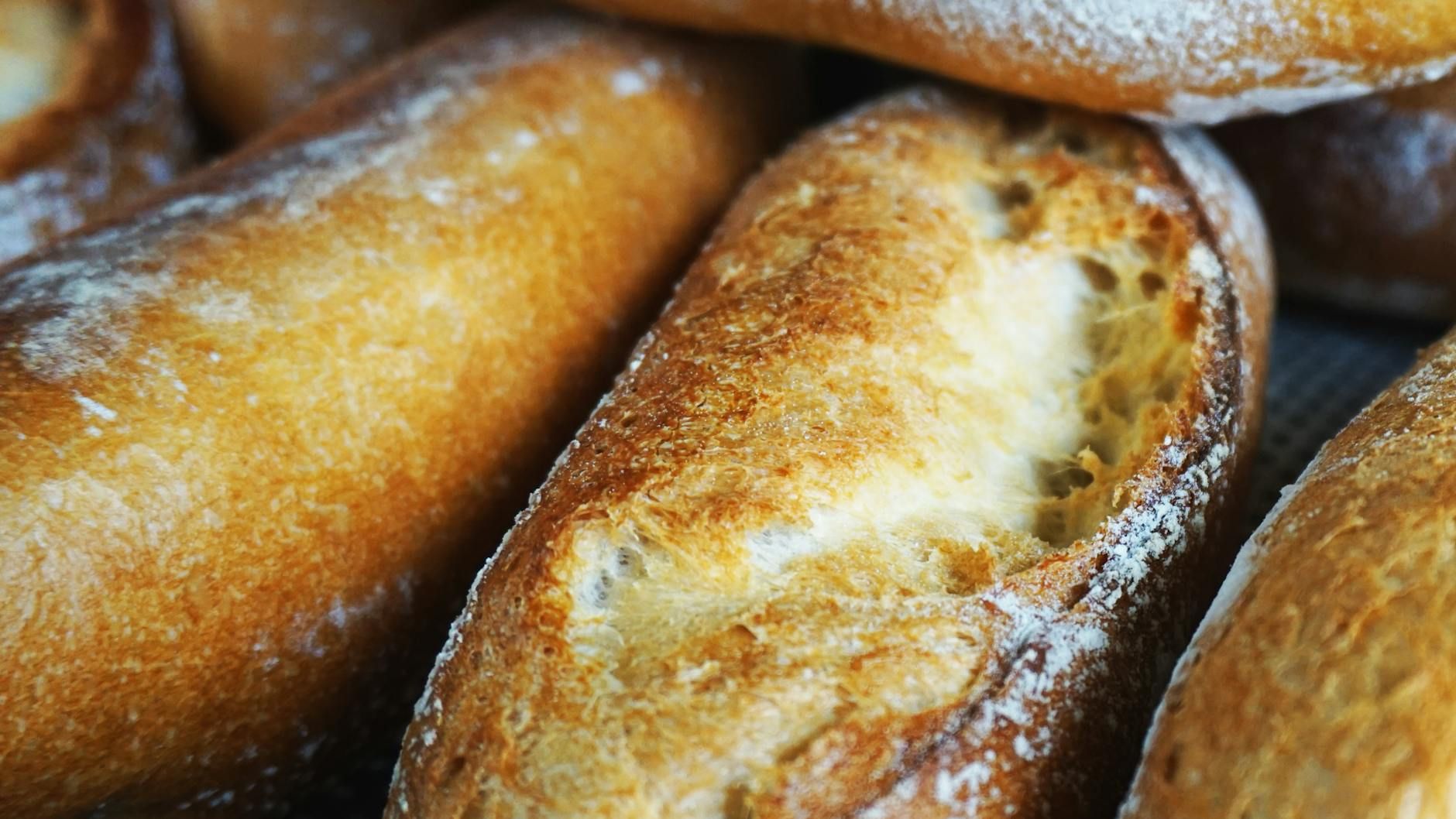 A detailed close-up of freshly baked baguettes, capturing the texture and golden crust. Taken in Hồ Chí Minh, Việt Nam.