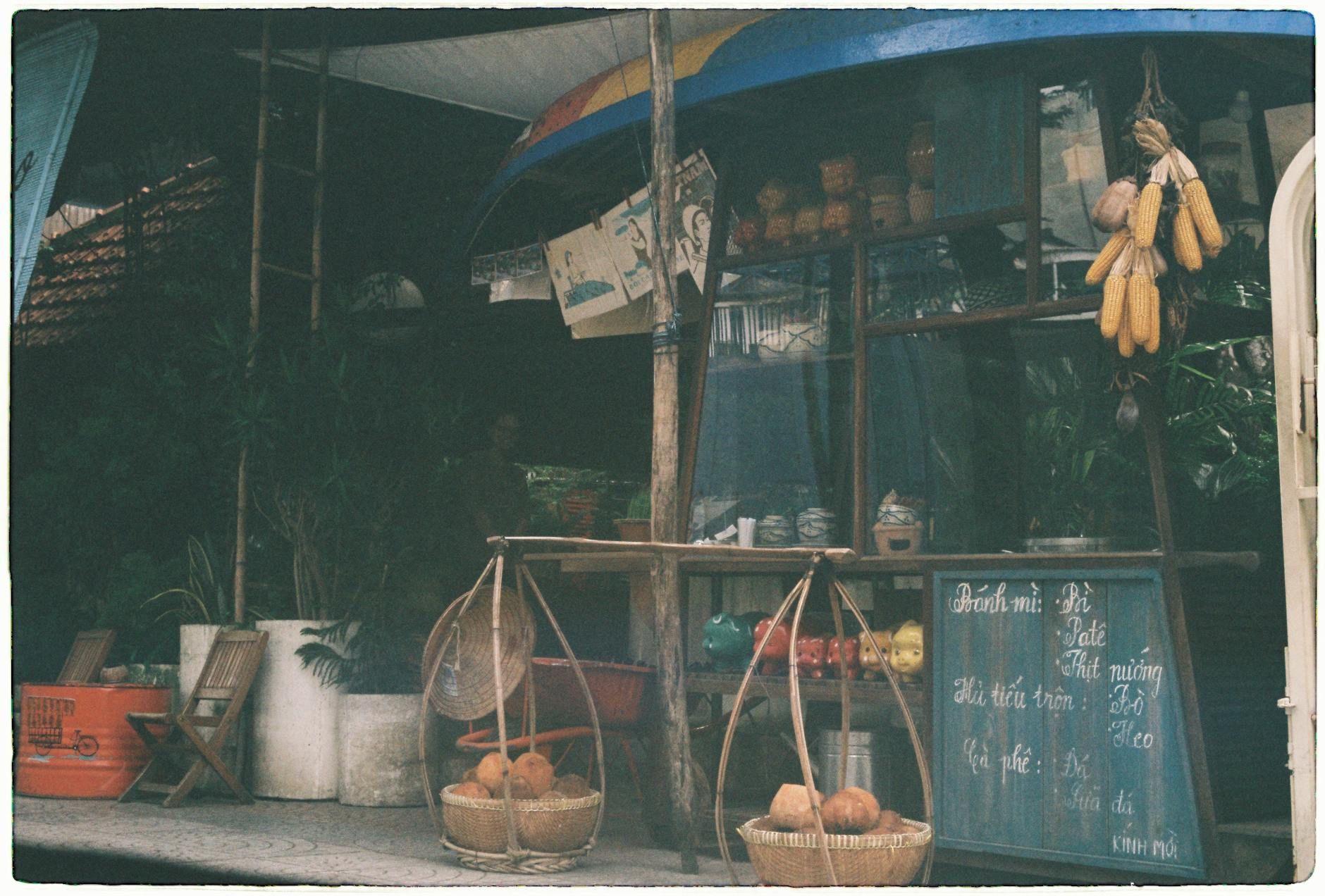 Vintage street stall in Ho Chi Minh City, showcasing local fruits and a rustic setting.